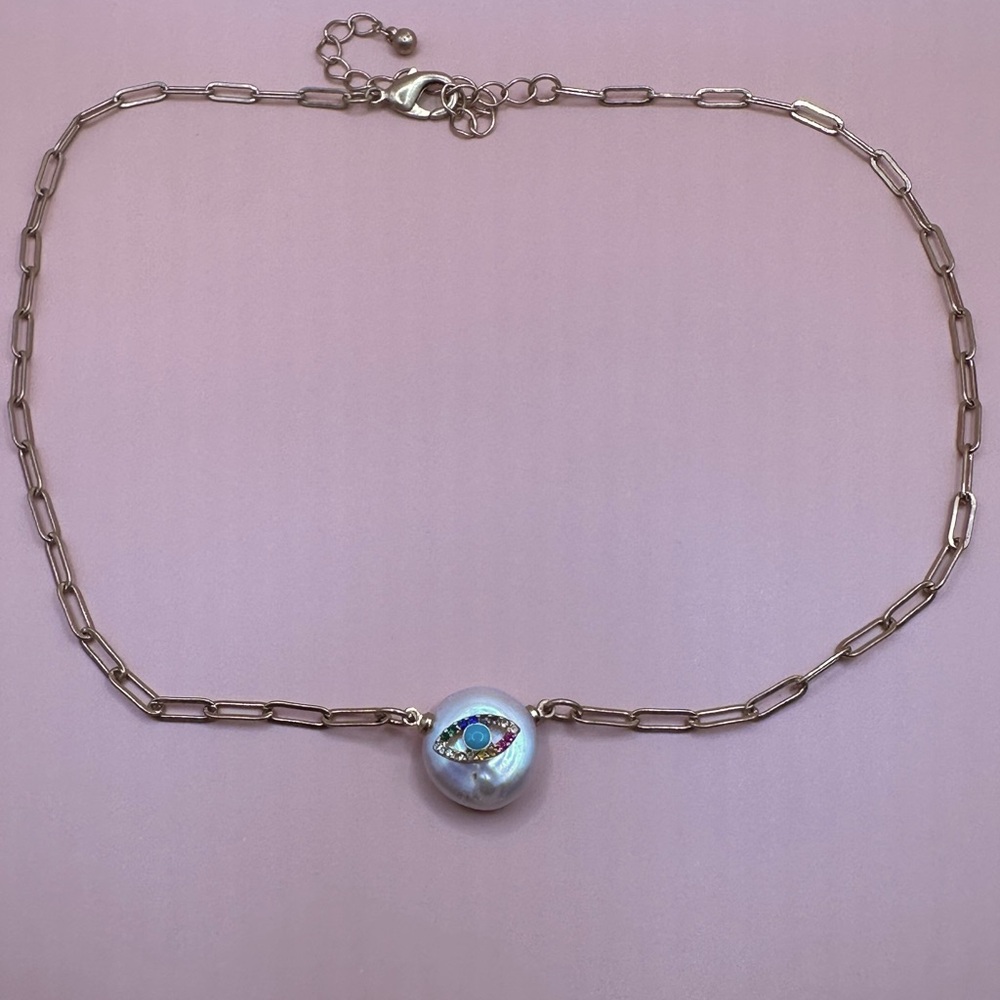 Gold necklace with pearl and eye designs